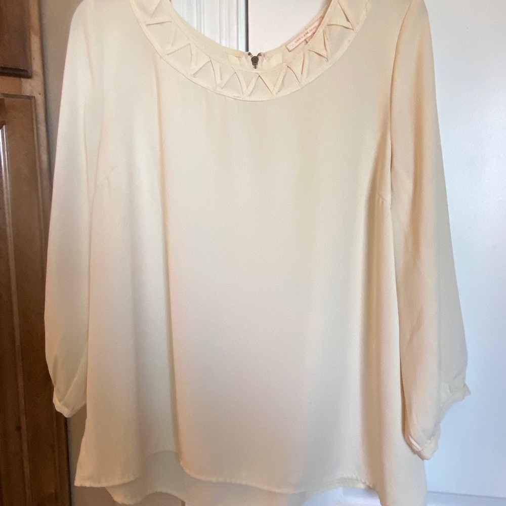 Cream top with detailed neckline. Size L
